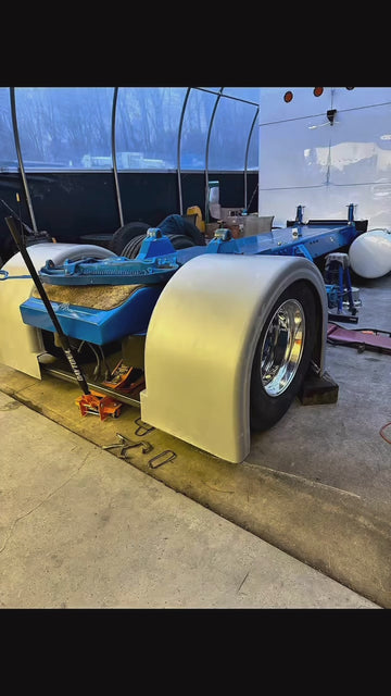Semi truck rear fender installation on chassis with polished chrome wheels